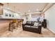 Open concept basement features a wet bar, leather couch, and recessed lighting for a cozy and inviting space at 9825 S Iris Ct, Littleton, CO 80127