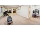 Spacious basement includes a wet bar, living area, exercise equipment and a bathroom with glass shower at 9825 S Iris Ct, Littleton, CO 80127