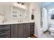 Well-lit bathroom featuring a vanity, toilet, and shower with modern fixtures at 9825 S Iris Ct, Littleton, CO 80127