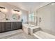 Luxurious bathroom with double vanity, soaking tub, glass-enclosed shower, and modern fixtures at 9825 S Iris Ct, Littleton, CO 80127