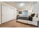 Comfortable bedroom featuring closet, large bed, and a small window that allows natural light in at 9825 S Iris Ct, Littleton, CO 80127