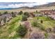 Aerial view showing a community of houses, manicured lawns, landscaping, and pathways leading to the homes at 9825 S Iris Ct, Littleton, CO 80127
