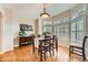 Sunlit dining room boasting hardwood floors and expansive windows with shutters at 9825 S Iris Ct, Littleton, CO 80127