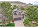 Stunning two-story home with a two-car garage, stone accents, mature trees, and mountain views at 9825 S Iris Ct, Littleton, CO 80127