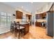 Spacious kitchen with granite counters, dark cabinets, and hardwood floors at 9825 S Iris Ct, Littleton, CO 80127