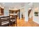 Open kitchen with granite counters, hardwood floors, and stainless steel appliances at 9825 S Iris Ct, Littleton, CO 80127