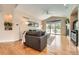 Bright living room with hardwood floors, vaulted ceiling, and sliding glass doors to the outside deck at 9825 S Iris Ct, Littleton, CO 80127