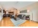 Bright living room with hardwood floors and a view of the open kitchen at 9825 S Iris Ct, Littleton, CO 80127