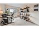 Home office with a desk, shelving, computer and natural light at 9825 S Iris Ct, Littleton, CO 80127