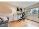 Bright home office with hardwood floors, modern furnishings, and natural light at 9825 S Iris Ct, Littleton, CO 80127