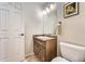 Stylish powder room features a vanity with stone counter, and picture, offering a functional and aesthetic design at 9825 S Iris Ct, Littleton, CO 80127