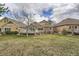 Backyard view showing the deck, stone accents and grassy lawn, perfect for relaxing and entertaining at 9825 S Iris Ct, Littleton, CO 80127
