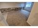 Spacious basement area with new carpet, stone accents, and a window for natural light at 14190 E Gunnison Pl, Aurora, CO 80012