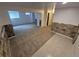 Open basement area with stone accents and neutral carpet for versatile use at 14190 E Gunnison Pl, Aurora, CO 80012
