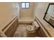 Cozy bathroom features a tub, toilet, and tiled walls for a clean and functional space at 14190 E Gunnison Pl, Aurora, CO 80012