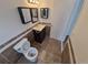 This bathroom includes a vanity, toilet, and modern light fixtures, with tiled accents at 14190 E Gunnison Pl, Aurora, CO 80012