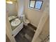 Cozy bathroom with a white toilet, white vanity, a gold-trimmed mirror, and a window at 14190 E Gunnison Pl, Aurora, CO 80012