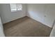 A bedroom with plush carpeting and a window at 14190 E Gunnison Pl, Aurora, CO 80012
