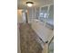 Inviting entryway with neutral-toned tile flooring, white walls, and views to the living room and fenced backyard at 14190 E Gunnison Pl, Aurora, CO 80012