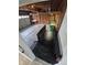 Spacious garage features exposed wood beams, storage shelving, and plenty of room for parking and projects at 14190 E Gunnison Pl, Aurora, CO 80012