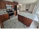 A modern kitchen with granite countertops, stainless steel appliances and a central island with seating at 14190 E Gunnison Pl, Aurora, CO 80012