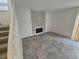 Open living room featuring a stone fireplace, neutral-toned tile flooring, and natural light at 14190 E Gunnison Pl, Aurora, CO 80012