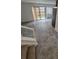 Bright living space with a sliding glass door to the backyard and neutral-toned tile flooring at 14190 E Gunnison Pl, Aurora, CO 80012