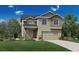 Charming two-story home featuring a craftsman-style design with a well-manicured lawn at 206 Welded Tuff Trl, Castle Rock, CO 80104