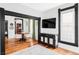 Living room view to dining area with hardwood floors and black-trimmed doorways at 4778 Williams St, Denver, CO 80216