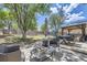 Spacious backyard featuring a patio with dining area, gazebo, fire pit, trampoline and lush landscaping at 11218 Newark Ct, Commerce City, CO 80640
