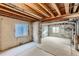 Unfinished basement featuring concrete walls, exposed ceiling, and carpeted area at 11218 Newark Ct, Commerce City, CO 80640