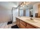 Bright bathroom featuring a double sink vanity and shower with chrome frame at 11218 Newark Ct, Commerce City, CO 80640
