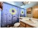 Bathroom with Sunflower shower curtain, wood cabinet and sink with large mirror at 11218 Newark Ct, Commerce City, CO 80640