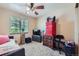 Comfortable bedroom features a ceiling fan, window view and unique decor at 11218 Newark Ct, Commerce City, CO 80640