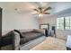 Bedroom with a comfortable bed, ceiling fan, and bright window that lets in natural light at 11218 Newark Ct, Commerce City, CO 80640