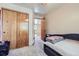 Cozy bedroom features plush carpet, closet space, and a view of the upper hallway at 11218 Newark Ct, Commerce City, CO 80640