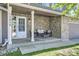 Inviting front porch with stone accent wall and seating area with cushions, creating a cozy outdoor space at 11218 Newark Ct, Commerce City, CO 80640