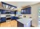 Modern kitchen with blue cabinets, stainless steel appliances, and ample counter space for cooking and meal preparation at 11218 Newark Ct, Commerce City, CO 80640