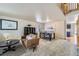 Cozy living room with neutral carpet, comfortable seating, and an adjacent dining area with stylish decor at 11218 Newark Ct, Commerce City, CO 80640