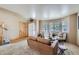 Inviting living room with hardwood floors, ample natural light, and a comfortable seating arrangement by the windows at 11218 Newark Ct, Commerce City, CO 80640