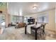 Open-concept living room with a combined seating and dining area, filled with natural light and stylish furnishings at 11218 Newark Ct, Commerce City, CO 80640
