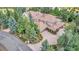 Aerial view of a home with tile roof, large driveway and lush landscaping at 28 Indian Paintbrush Dr, Golden, CO 80401
