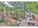Outdoor patio with stone staircase, arched cooking area, and bar with seating at 28 Indian Paintbrush Dr, Golden, CO 80401