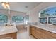 Elegant bathroom with dual vanities, soaking tub, and decorative leaded glass windows at 28 Indian Paintbrush Dr, Golden, CO 80401