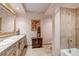 Well-appointed bathroom featuring detailed tile work, a vanity, and combined shower and bathtub at 28 Indian Paintbrush Dr, Golden, CO 80401