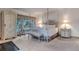 Serene bedroom featuring a four-poster bed, garden view, and calming ambiance at 28 Indian Paintbrush Dr, Golden, CO 80401