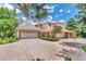 Beautiful exterior elevation of a home with garages, brick accents and a tile roof at 28 Indian Paintbrush Dr, Golden, CO 80401