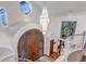 Grand foyer showcasing a custom wood front door, soaring ceilings, and a decorative chandelier at 28 Indian Paintbrush Dr, Golden, CO 80401