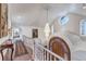Elegant foyer with a curved staircase, custom front door, chandelier, and architectural details at 28 Indian Paintbrush Dr, Golden, CO 80401