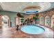 Luxurious indoor pool area with stone waterfall, unique architectural details, and recessed lighting at 28 Indian Paintbrush Dr, Golden, CO 80401